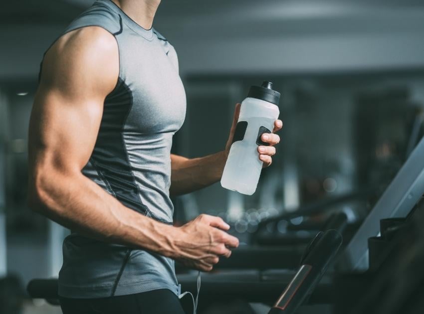 man running on a treadmill at a gym