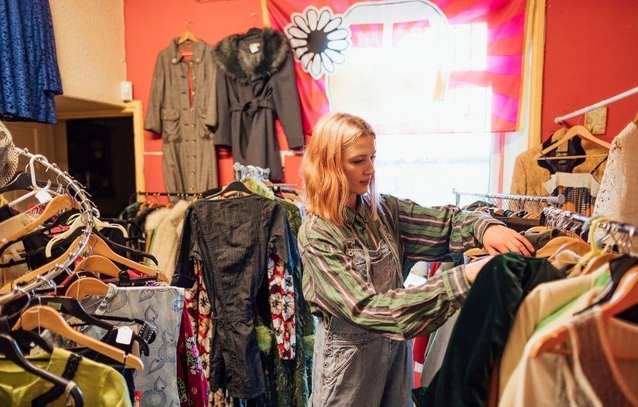 a customer searching for a blouse at a thrift store